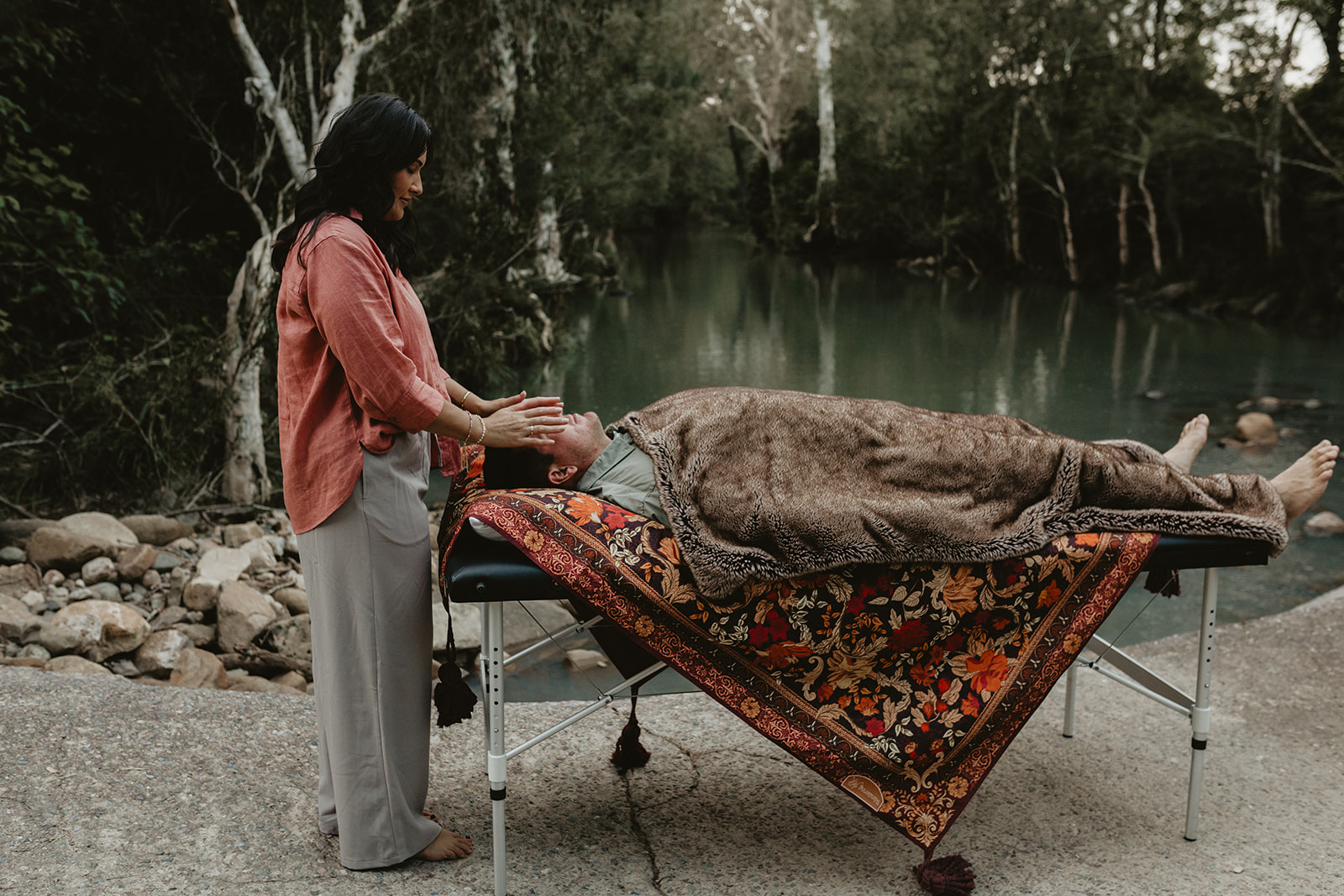 Sacred Energy Healing card showing Charlene holding sacred space for a client outdoors near the river in Sarina QLD, offering deep emotional release and spiritual healing.