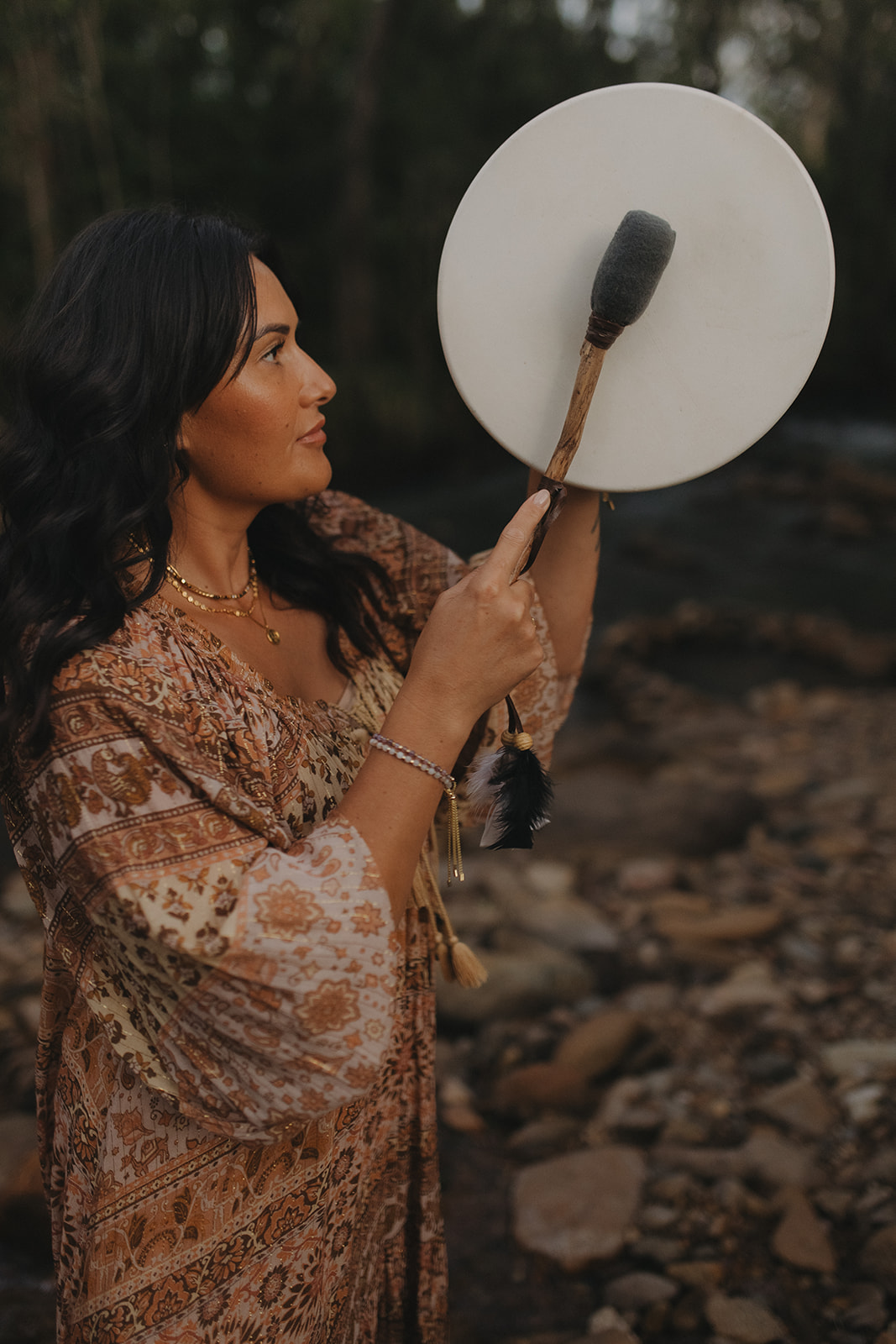 Charlene performing a smoke cleansing ritual beside a still creek in Sarina QLD during an intuitive energy healing ceremony for spiritual clearing and connection.